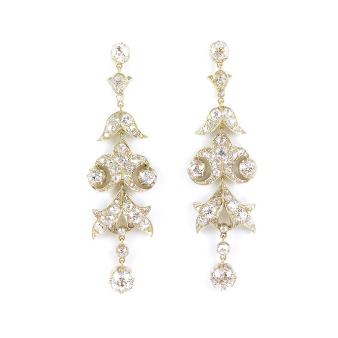 Diamond scroll cluster pendant earrings each hung with a cushion cut diamond collet | MasterArt